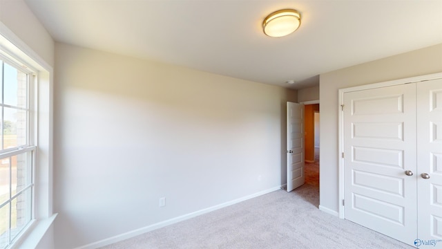 209 Roman Randall Rd, New Market, AL 35761 - unfurnished bedroom with light carpet, a closet, and baseboards