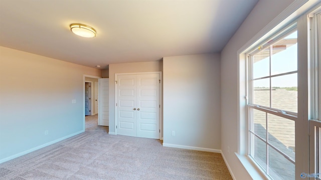 209 Roman Randall Rd, New Market, AL 35761 - unfurnished bedroom featuring a closet, baseboards, and light carpet