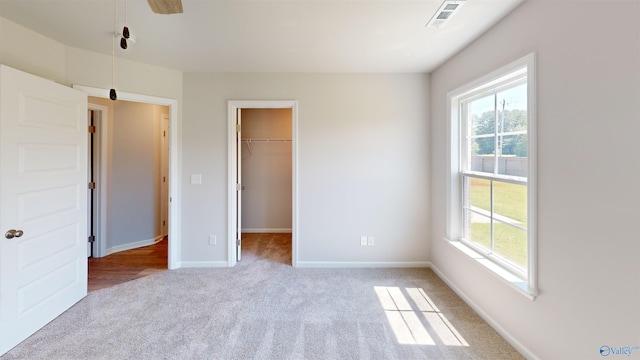 209 Roman Randall Rd, New Market, AL 35761 - unfurnished bedroom with light carpet, a spacious closet, multiple windows, and visible vents