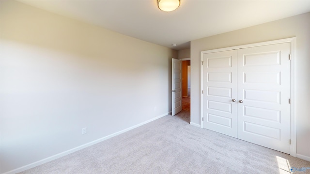 209 Roman Randall Rd, New Market, AL 35761 - unfurnished bedroom featuring a closet, baseboards, and light colored carpet