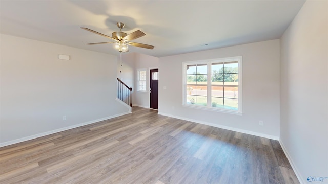 209 Roman Randall Rd, New Market, AL 35761 - unfurnished room with baseboards, stairway, visible vents, ceiling fan, and wood finished floors