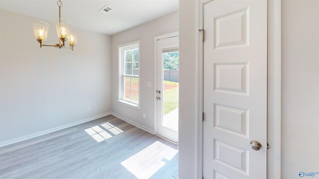 209 Roman Randall Rd, New Market, AL 35761 - doorway to outside with light wood-style floors, a notable chandelier, visible vents, and baseboards