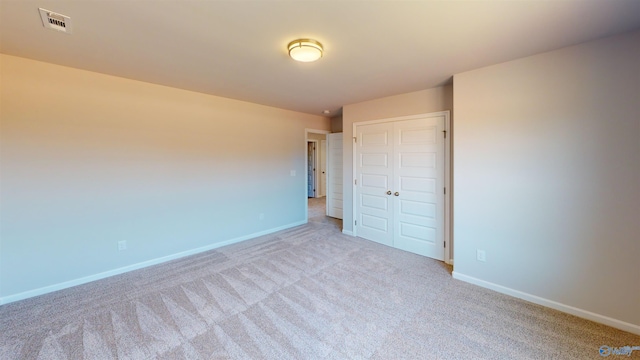 209 Roman Randall Rd, New Market, AL 35761 - unfurnished bedroom featuring light carpet, a closet, baseboards, and visible vents