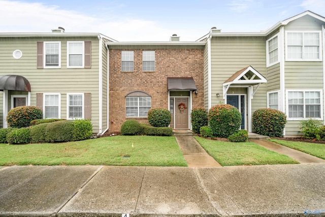 view of property featuring a front lawn