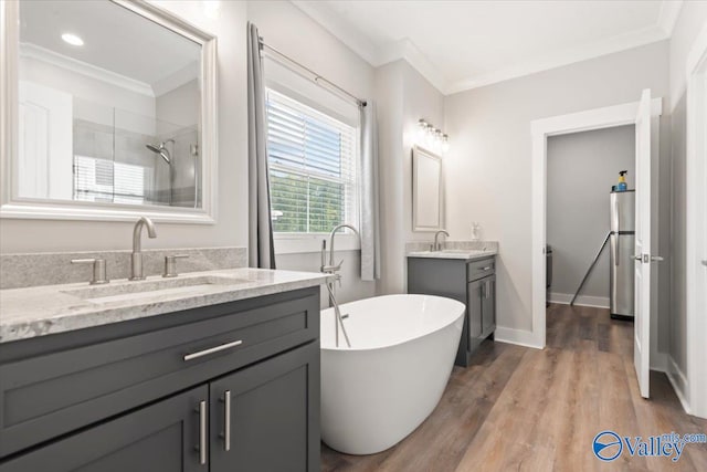 bathroom with vanity, crown molding, hardwood / wood-style floors, and separate shower and tub