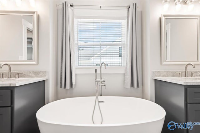 bathroom with a bath and vanity