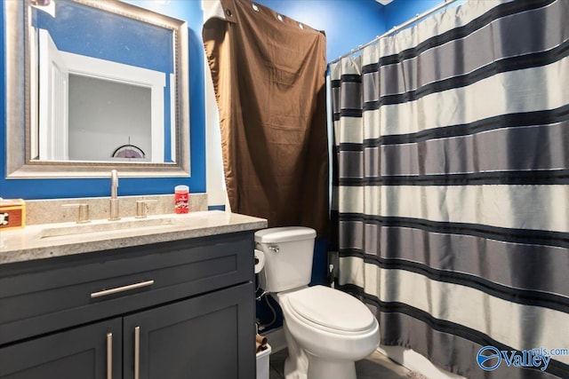 bathroom featuring vanity, toilet, and a shower with shower curtain