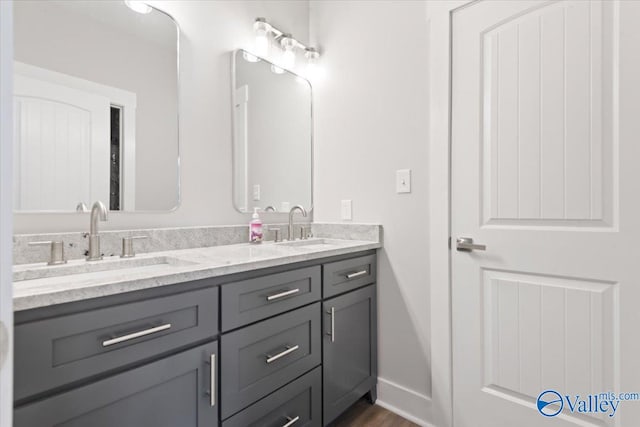 bathroom with vanity and hardwood / wood-style floors