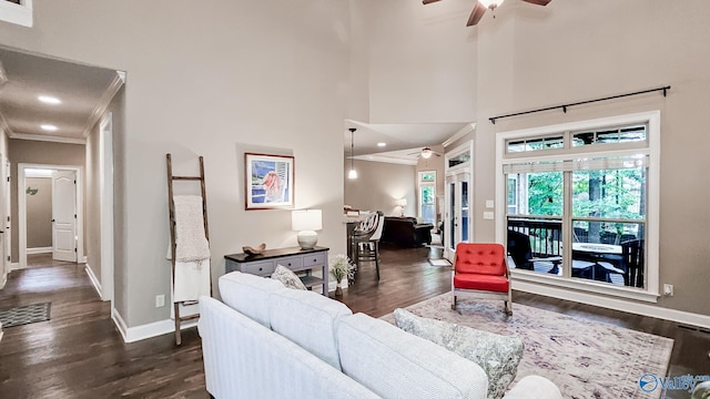 10 Verdant Cir SE, Huntsville, AL 35803 - living room featuring ceiling fan, ornamental molding, baseboards, dark wood-type flooring, and a high ceiling