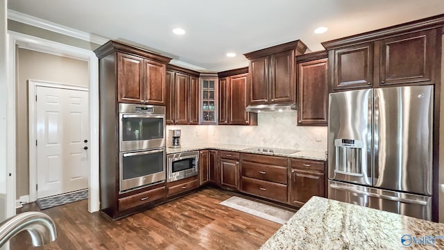 10 Verdant Cir SE, Huntsville, AL 35803 - kitchen with stainless steel appliances, ornamental molding, under cabinet range hood, light stone counters, and dark brown cabinets