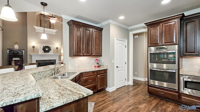 10 Verdant Cir SE, Huntsville, AL 35803 - kitchen with appliances with stainless steel finishes, a sink, dark brown cabinetry, tasteful backsplash, and ceiling fan