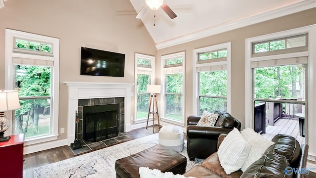 10 Verdant Cir SE, Huntsville, AL 35803 - living room featuring a ceiling fan, a tiled fireplace, vaulted ceiling, wood finished floors, and baseboards