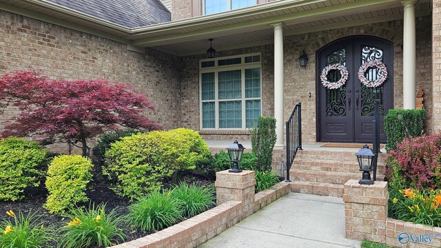 10 Verdant Cir SE, Huntsville, AL 35803 - view of exterior entry featuring brick siding, a shingled roof, and a porch
