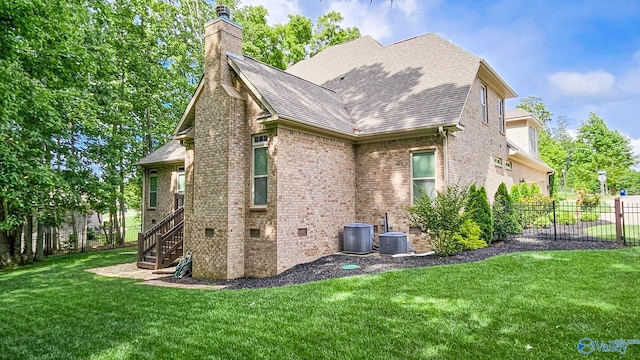 10 Verdant Cir SE, Huntsville, AL 35803 - view of property exterior featuring a chimney, brick siding, and roof with shingles