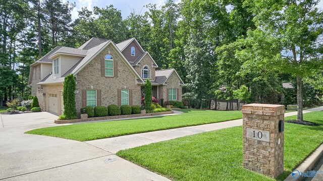 10 Verdant Cir SE, Huntsville, AL 35803 - traditional-style house with concrete driveway, brick siding, a front lawn, and a shingled roof