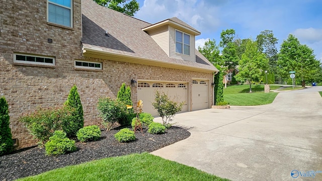 10 Verdant Cir SE, Huntsville, AL 35803 - view of property exterior with driveway, a yard, a shingled roof, brick siding, and a garage