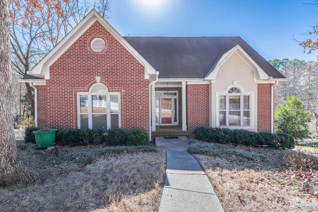 view of front of house with brick siding and stucco siding