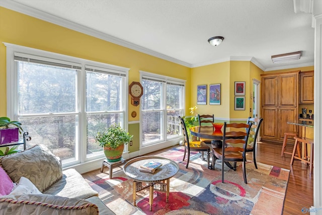 living area featuring light wood-style floors and ornamental molding