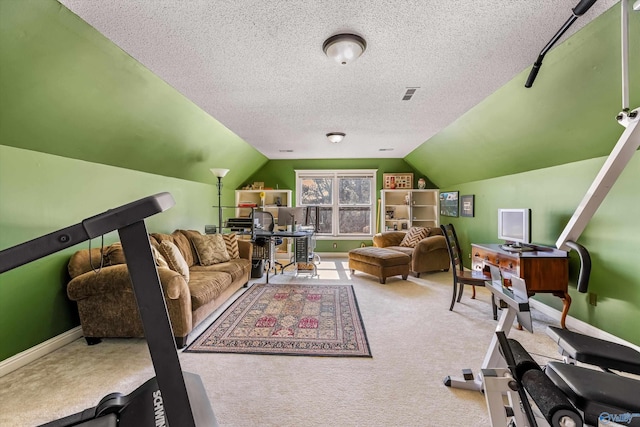 workout room with visible vents, a textured ceiling, baseboards, carpet, and lofted ceiling