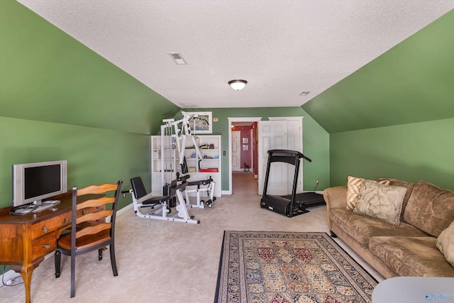 office with baseboards, visible vents, vaulted ceiling, a textured ceiling, and carpet flooring