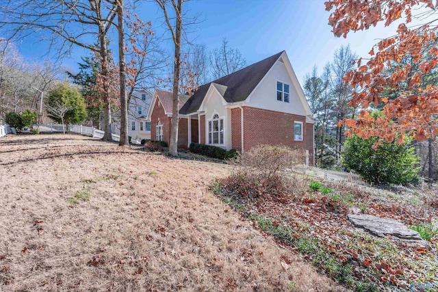 view of side of home with brick siding and stucco siding