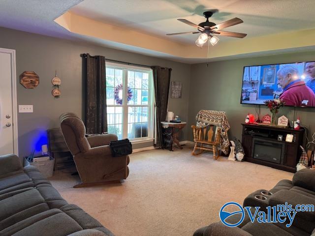 117 Simmons Cir, Fayetteville, TN 37334 - living area featuring a tray ceiling, a ceiling fan, and carpet floors
