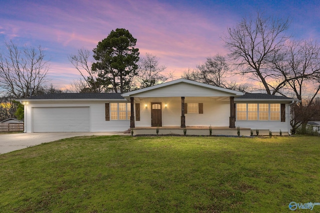 ranch-style house with an attached garage, a lawn, covered porch, and driveway