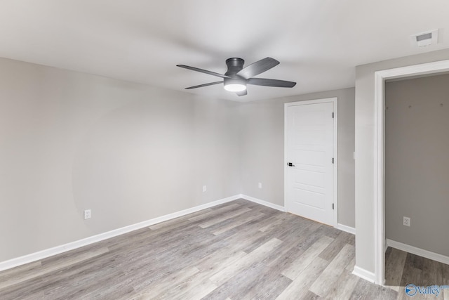 unfurnished room with visible vents, baseboards, a ceiling fan, and wood finished floors