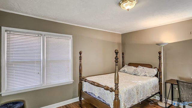 bedroom with dark wood-type flooring, crown molding, and multiple windows