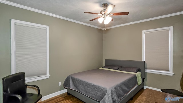 bedroom featuring ornamental molding, dark wood-type flooring, a textured ceiling, and ceiling fan