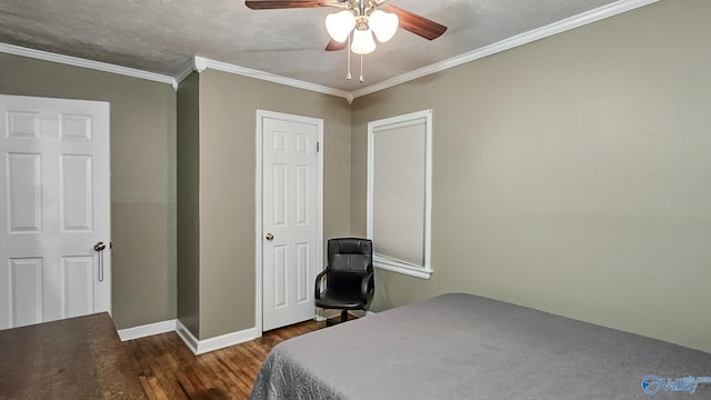 bedroom featuring a textured ceiling, dark wood-type flooring, ornamental molding, and ceiling fan