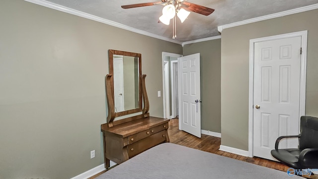 bedroom featuring crown molding, dark wood-type flooring, and ceiling fan