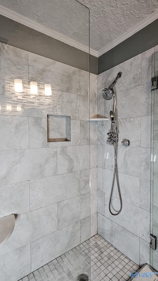 bathroom featuring crown molding, a textured ceiling, and walk in shower