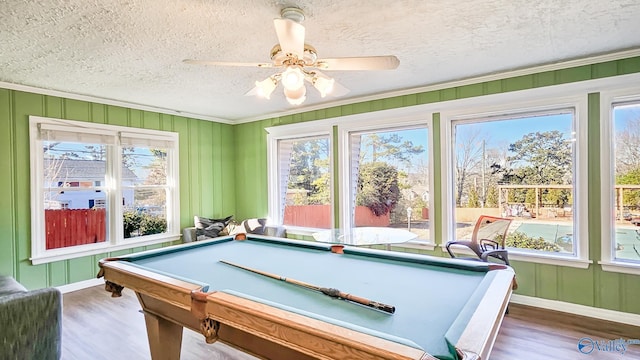 playroom featuring plenty of natural light and dark hardwood / wood-style floors