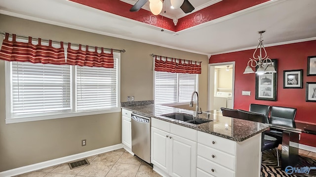 kitchen with sink, white cabinets, hanging light fixtures, stainless steel dishwasher, and crown molding