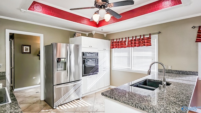 kitchen with sink, ornamental molding, black appliances, white cabinets, and a raised ceiling