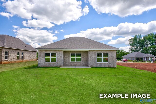 rear view of house featuring a yard and a patio