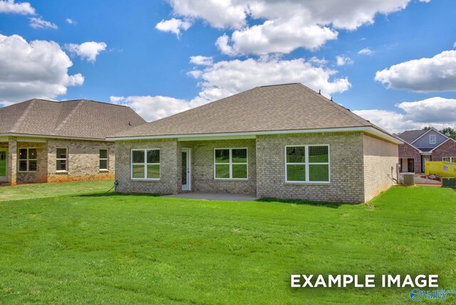 rear view of house featuring a yard