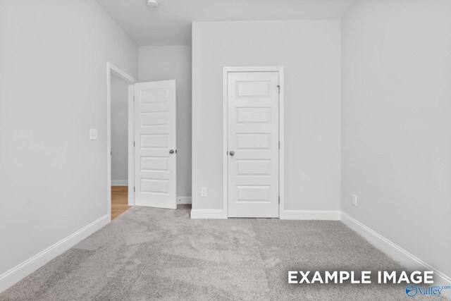 unfurnished bedroom featuring carpet and a closet