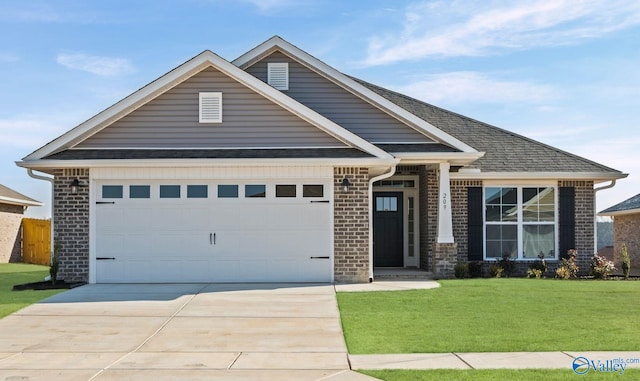 craftsman house with a garage and a front yard