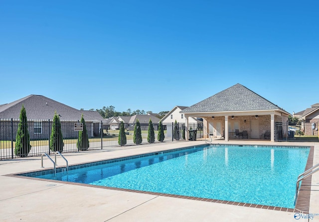 view of swimming pool with ceiling fan and a patio