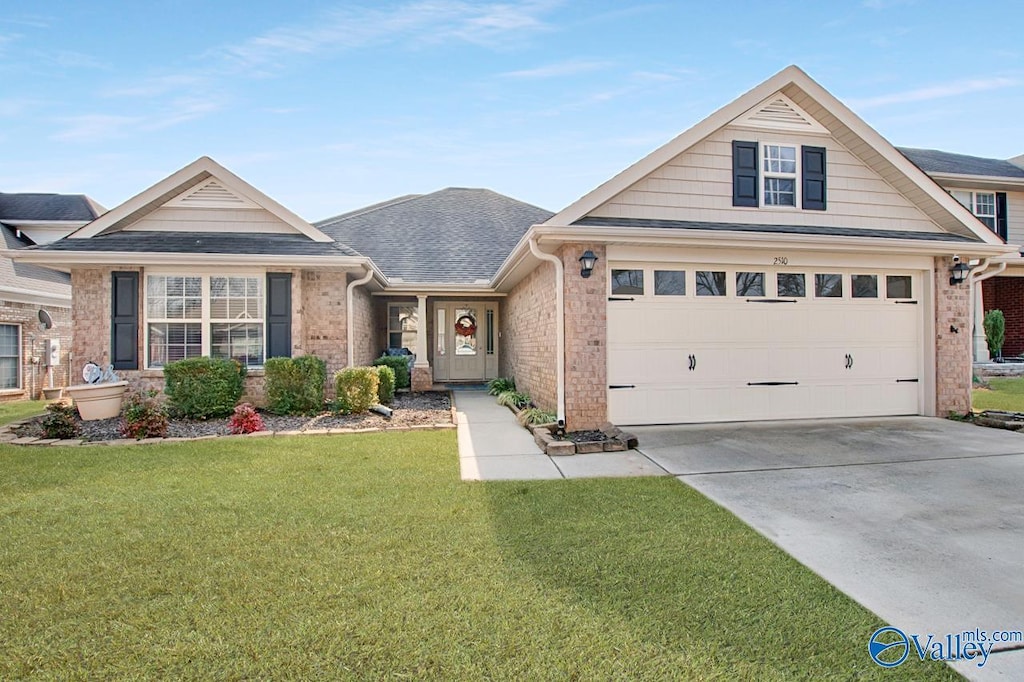 view of front of property featuring a garage and a front yard