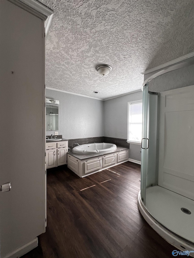 unfurnished bedroom featuring dark wood finished floors, crown molding, a sink, and a textured ceiling