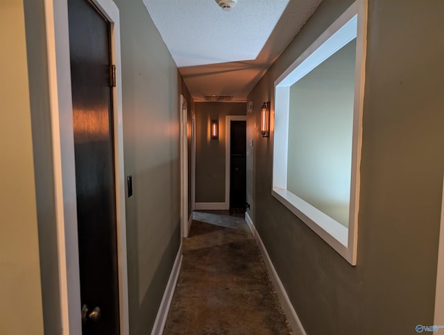 hallway featuring a textured ceiling