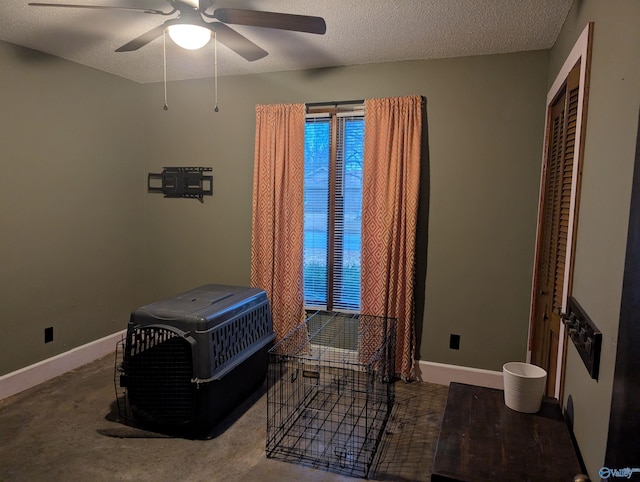 carpeted bedroom with ceiling fan, a closet, and a textured ceiling