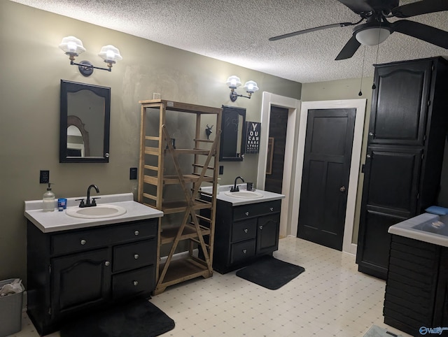 bathroom with vanity, a textured ceiling, and ceiling fan