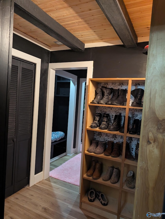 interior space with beamed ceiling, wood-type flooring, and wooden ceiling