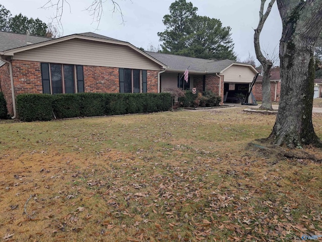 ranch-style home with a front yard and a carport