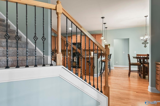 stairs featuring baseboards and wood finished floors