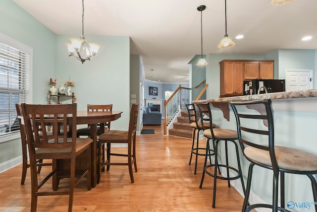 dining area with baseboards, a chandelier, stairs, recessed lighting, and light wood-style flooring